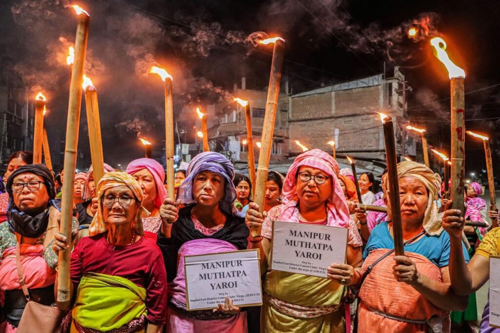 Manipur Violence 2026 protest scene with security forces and road blockade